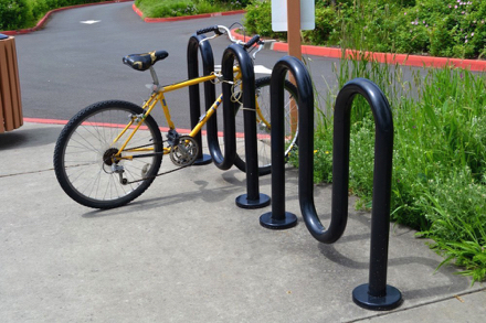 Bike rack located on the sidewalk off parking lot - bikes are not allowed on any trail